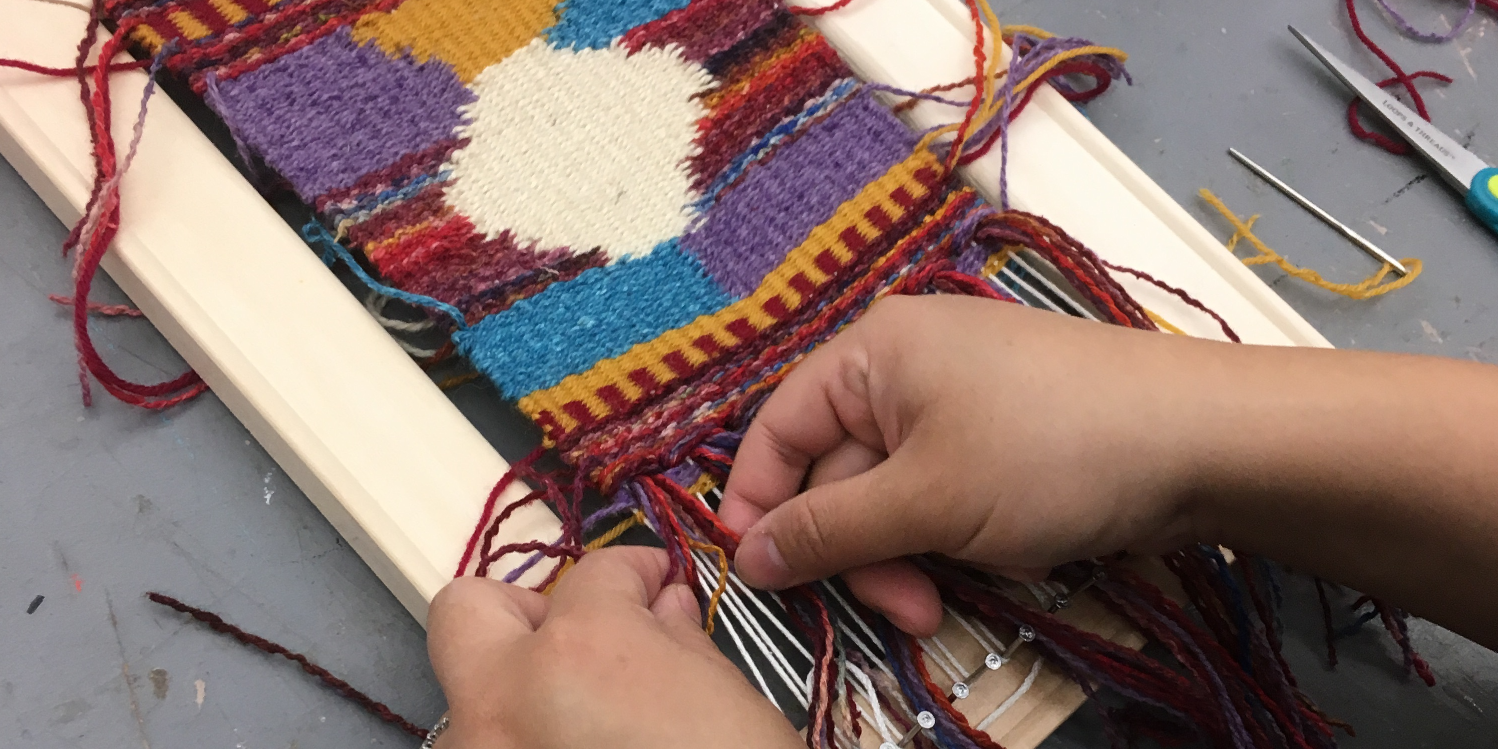 Weaving web Hands weaving on a loom