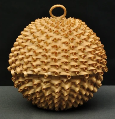 A flax coloured spherical woven basket