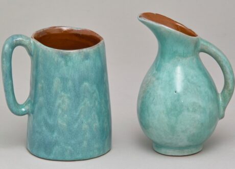 A light blue ceramic milk jug and creamer