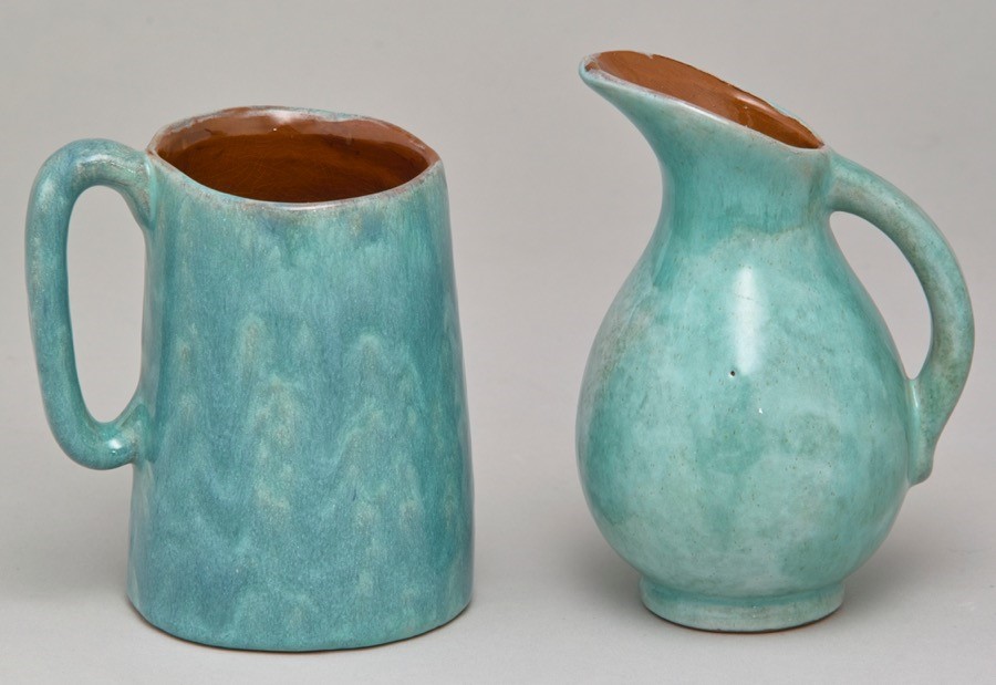 A light blue ceramic milk jug and creamer