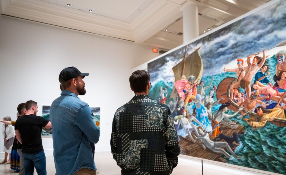 Four men look at a large painting in a Gallery